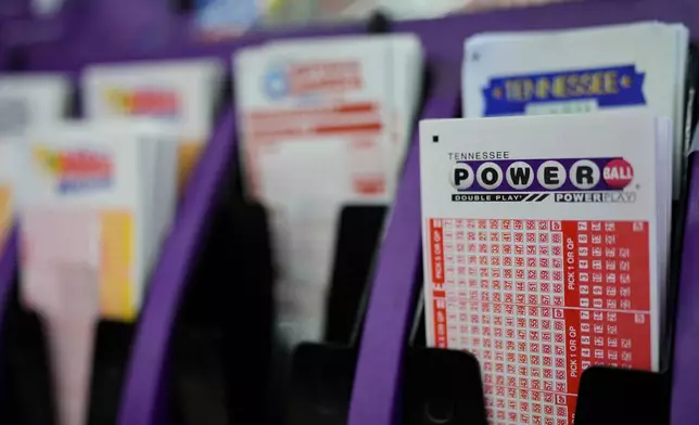 A Powerball play slip is seen at a store Wednesday, Dec. 17, 2025, in Nashville, Tenn. (AP Photo/George Walker IV)