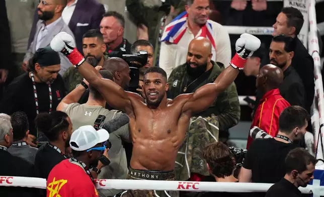Anthony Joshua celebrates after his win in the heavyweight boxing match against Jake Paul, Friday, Dec. 19, 2025, in Miami, Fla. (AP Photo/Lynne Sladky)