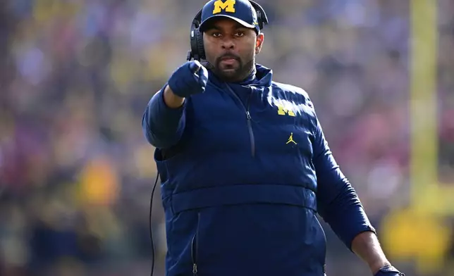 FILE - Michigan acting head coach Sherrone Moore reacts to a video replay during the first half of an NCAA college football game against Ohio State, Saturday, Nov. 25, 2023, in Ann Arbor, Mich. (AP Photo/David Dermer, File)