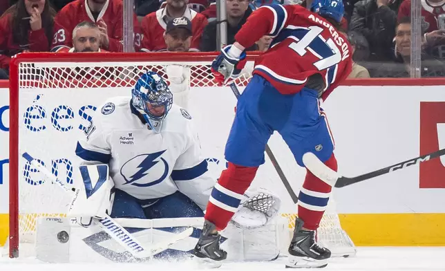 Tampa Bay Lightning goaltender Jonas Johansson (31) makes a save on Montreal Canadiens' Josh Anderson (17) during second period NHL hockey action in Montreal on Tuesday, Dec. 9, 2025. (Christopher Katsarov/The Canadian Press via AP)