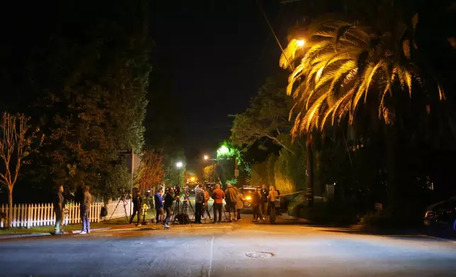 News media gather near Rob Reiner's residence Sunday, Dec. 14, 2025, in the Brentwood section of Los Angeles. (AP Photo/Ethan Swope)