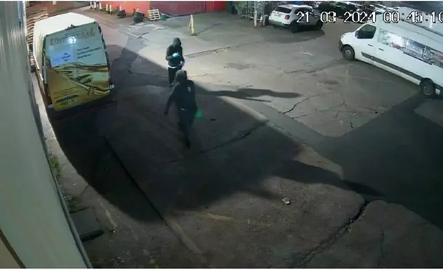 FILE - In this 2024 handout photo provided by the Metropolitan Police, two people can be seen shortly before authorities say they set fire to a warehouse in east London. (London Metropolitan Police via AP, File)