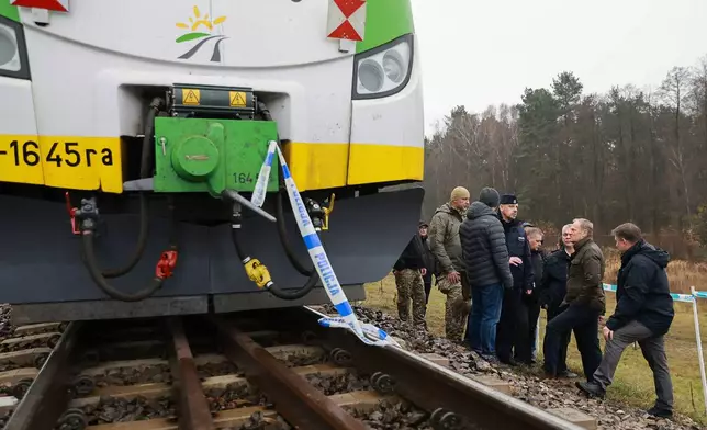 FILE - Polish Prime Minister Donald Tusk, second right, visits the sabotaged rail line near Mika, Poland, Nov. 17, 2025. (AP Photo/KPRM, File)