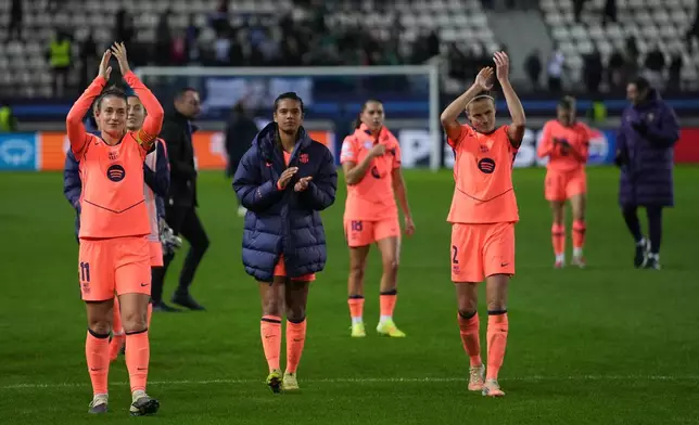 Barcelona players celebrate after a Women's Champions League soccer match between Paris FC and Barcelona in Paris, Wednesday, Dec. 17, 2025. (AP Photo/Thibault Camus)