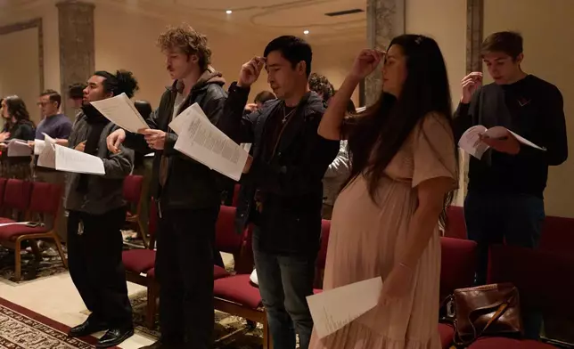 People sing and pray during service at St. Sophia Greek Orthodox Cathedral Tuesday, Nov. 18, 2025, in Los Angeles. (AP Photo/Allison Dinner)