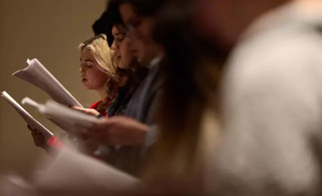People sing during service at St. Sophia Greek Orthodox Cathedral Tuesday, Nov. 18, 2025, in Los Angeles. (AP Photo/Allison Dinner)
