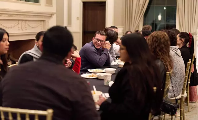 People gather after church service for the Young Adult Gathering Dinner and Discussion event at St. Sophia Greek Orthodox Cathedral Tuesday, Nov. 18, 2025, in Los Angeles. (AP Photo/Allison Dinner)