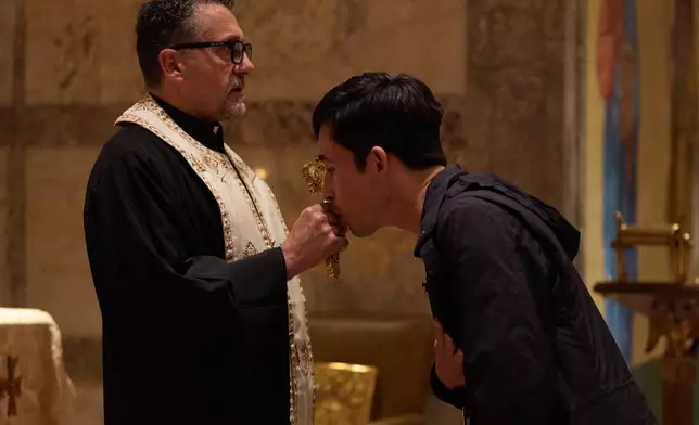 A person kisses the cross during service at St. Sophia Greek Orthodox Cathedral Tuesday, Nov. 18, 2025, in Los Angeles. (AP Photo/Allison Dinner)