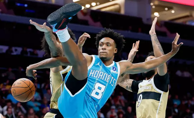 Charlotte Hornets guard Collin Sexton (8) passes behind him during the first half of an NBA basketball game against the Washington Wizards in Charlotte, N.C., Tuesday, Dec. 23, 2025. (AP Photo/Nell Redmond)
