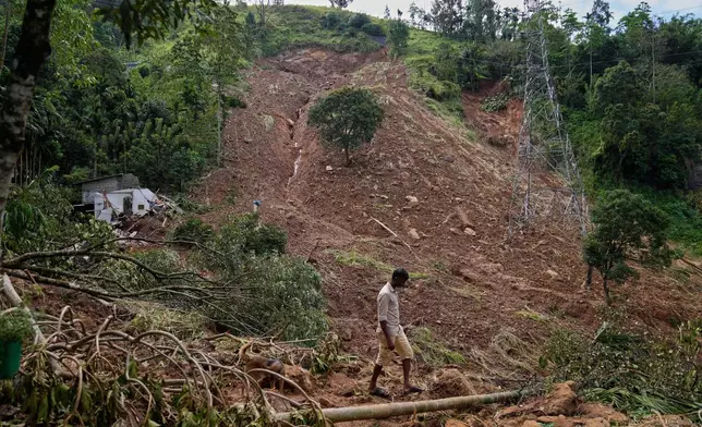 FILE - A landslide survivor searches for belongings at the site in the aftermath of Cyclone Ditwah in Sarasavigama village in Kandy, Sri Lanka, Dec. 1, 2025. (AP Photo/Eranga Jayawardena, File)