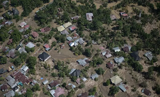FILE - This photo taken from a national disaster mitigation agency's helicopter during an aerial aid distribution shows an area affected by floods in the aftermath of Cyclone Senyar in Pidie Jaya, Aceh province, Indonesia, Dec. 4, 2025. (AP Photo/Reza Saifullah, File)