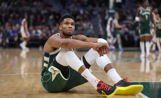 Milwaukee Bucks' Giannis Antetokounmpo reacts after suffering an injury during the first half an NBA basketball game against the Detroit Pistons, Wednesday, Dec. 3, 2025, in Milwaukee. (AP Photo/Kylie Bridenhagen)