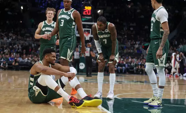Milwaukee Bucks' Giannis Antetokounmpo reacts after suffering an injury during the first half an NBA basketball game against the Detroit Pistons, Wednesday, Dec. 3, 2025, in Milwaukee. (AP Photo/Kylie Bridenhagen)