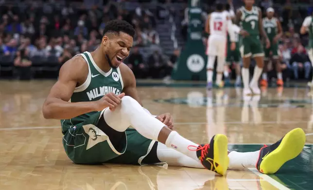 Milwaukee Bucks' Giannis Antetokounmpo reacts after suffering an injury during the first half an NBA basketball game against the Detroit Pistons, Wednesday, Dec. 3, 2025, in Milwaukee. (AP Photo/Kylie Bridenhagen)