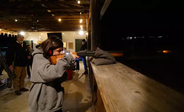 Mick Wysocky, 12, fires a shotgun during a turkey shoot at Moose Lodge 1318 in Wake Forest, N.C., on Friday, Dec. 12, 2025. (AP Photo/Allen G. Breed)