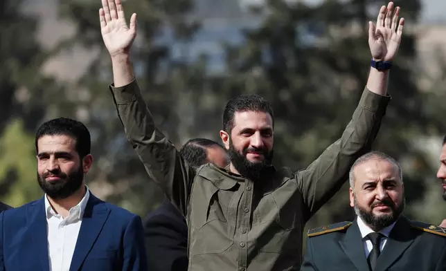 Syria's interim president, Ahmad al-Sharaa, greets people as he attends celebrations marking the first anniversary of the ousting of former President Bashar Assad in Damascus, Syria, Monday, Dec. 8, 2025. (AP Photo/Omar Sanadiki) I