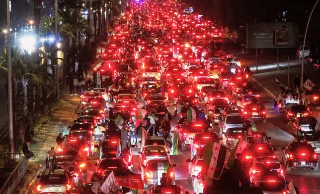 Syrians celebrate the first anniversary of the ousting of the Bashar Assad regime in Damascus, Syria, early Saturday, Dec. 6, 2025. (AP Photo/Ghaith Alsayed)