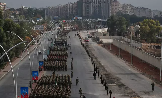 Members of the new Syrian army line up in formation during a parade marking the first anniversary of the ousting of former President Bashar Assad, in Damascus, Syria, Monday, Dec. 8, 2025. (AP Photo/Omar Sanadiki)