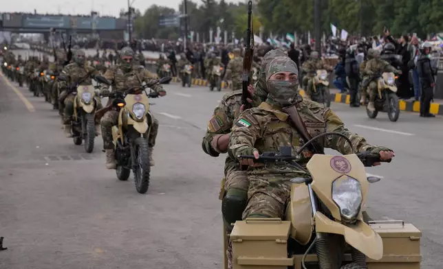 New Syrian army ride their motorcycles during a parade marking the first anniversary of the ousting of former President Bashar Assad in Damascus, Syria, Monday, Dec. 8, 2025. (AP Photo/Hussein Malla)