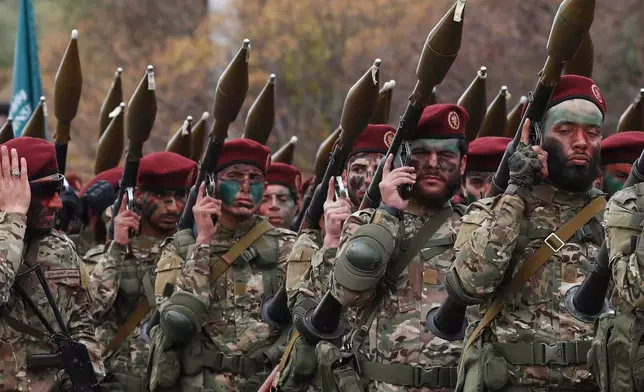 Fighters from the new Syrian army march with rocket-propelled grenade launchers during a parade marking the first anniversary of the ousting of former President Bashar Assad in Damascus, Syria, Monday, Dec. 8, 2025. (AP Photo/Omar Sanadiki)