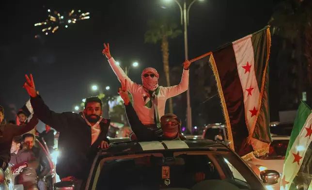 Syrians celebrate the first anniversary of the ousting of the Bashar Assad regime in Damascus, Syria, early Saturday, Dec. 6, 2025. (AP Photo/Ghaith Alsayed)