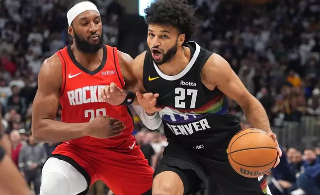 Denver Nuggets guard Jamal Murray, right, drives past Houston Rockets guard Josh Okogie, left, in the first half of an NBA basketball game Saturday, Dec. 20, 2025, in Denver. (AP Photo/David Zalubowski)
