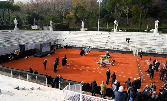 The coffin of Nicola Pietrangeli, Italian tennis champion of the 1950s and 1960s, is laid at the Pietrangeli tennis court at the Foro Italico ahead of the funeral service in Rome, Wednesday, Dec. 3, 2025. (AP Photo/Gregorio Borgia)