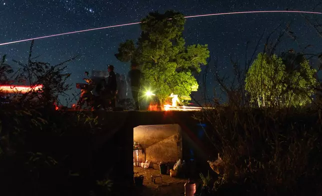 Village security volunteer patrol while Thai military fires artillery towards Cambodia, Saturday, Dec. 20, 2025, in Surin province, Thailand. (AP Photo/Wason Wanichakorn)
