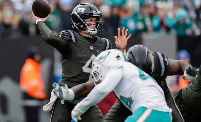 New York Jets quarterback Brady Cook (4) passes against the Miami Dolphins during the second quarter of an NFL football game, Sunday, Dec. 7, 2025, in East Rutherford, N.J. (AP Photo/Adam Hunger)