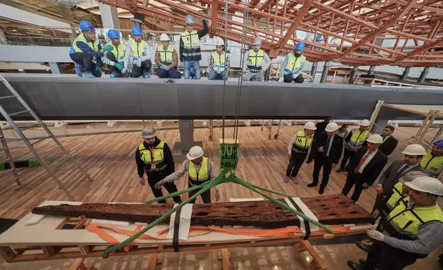 Archeologists prepare to reassemble the second solar boat of King Khufu, at the Grand Egyptian Museum in Giza, Egypt, Tuesday, Dec. 23, 2025. (AP Photo/Amr Nabil)