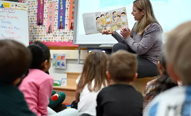 Kindergarten teacher Christin Labriola reads the book "Dumpling Soup" to her class, incorporating Asian American and Pacific Islander subjects in her class at Webster Hill Elementary School in West Hartford, Conn., on Dec. 2, 2025. (AP Photo/Jessica Hill)