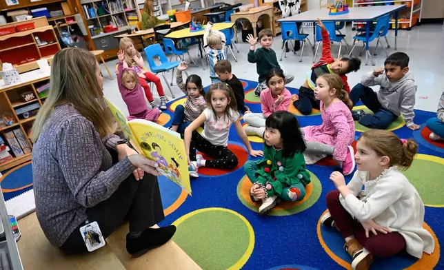 Kindergarten teacher Christin Labriola reads the book "Dumpling Soup" to her class, incorporating Asian American and Pacific Islander subjects in her class at Webster Hill Elementary School in West Hartford, Conn., on Dec. 2, 2025. (AP Photo/Jessica Hill)