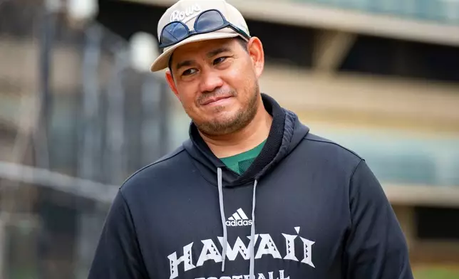 Hawaii head coach Timmy Chang smiles during an interview, Tuesday, Dec. 16, 2025, in Honolulu. (AP Photo/Mengshin Lin)