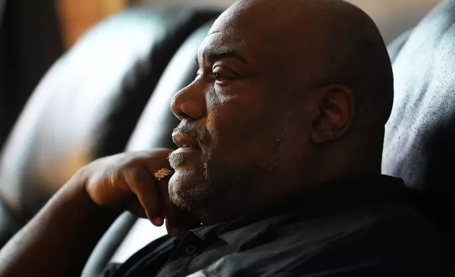 Ahmad Collins watches television in his home in Harrisburg, Pa., Thursday, Dec. 11, 2025. A city government worker and former Penn State linebacker, Collins has needed 10 hours a night of dialysis since a medical procedure left him with damaged kidneys late last year. (AP Photo/Matt Rourke)