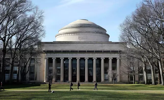 FILE - Students walk past the "Great Dome" atop Building 10 on the Massachusetts Institute of Technology campus in Cambridge, Mass., April 3, 2017. (AP Photo/Charles Krupa, File)