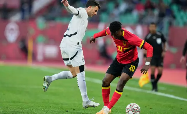 Angola's Gelson Dala, right, controls the ball past Egypt's Ahmed Zizo during the Africa Cup of Nations group B soccer match between Angola and Egypt in Agadir, Morocco, Monday, Dec. 29, 2025. (AP Photo/Mosa'ab Elshamy)