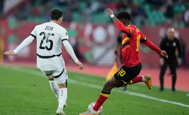 Angola's Gelson Dala, right, kicks the ball during the Africa Cup of Nations group B soccer match between Angola and Egypt in Agadir, Morocco, Monday, Dec. 29, 2025. (AP Photo/Mosa'ab Elshamy)