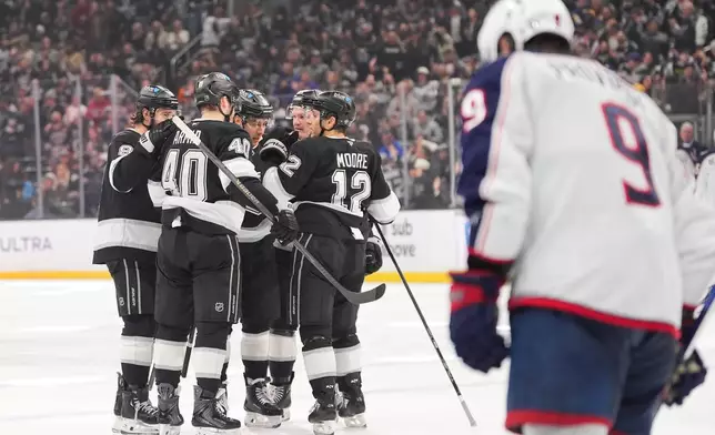 Los Angeles Kings players celebrate a goal by Andrei Kuzmenko during the second period of an NHL hockey game against the Columbus Blue Jackets Monday, Dec. 22, 2025, in Los Angeles. (AP Photo/Jae C. Hong)