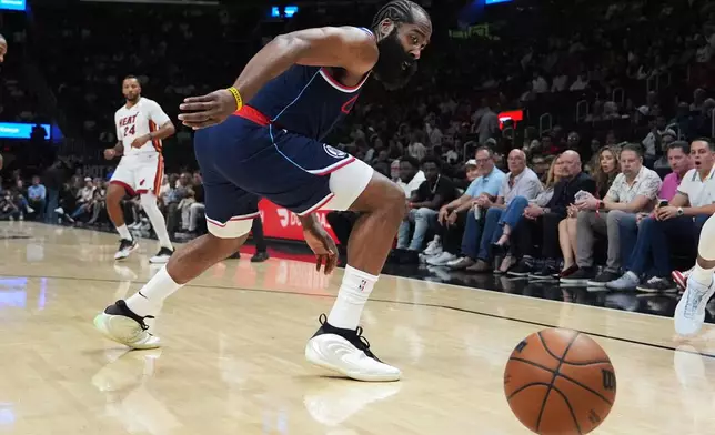 Los Angeles Clippers guard James Harden goes for a loose ball during the first half of an NBA basketball game against the Miami Heat, Monday, Dec. 1, 2025, in Miami. (AP Photo/Lynne Sladky)