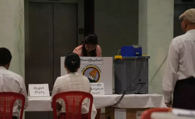 A voter casts a ballot at a polling station, Sunday, Dec. 28, 2025, in Yangon, Myanmar. (AP Photo/Thein Zaw)