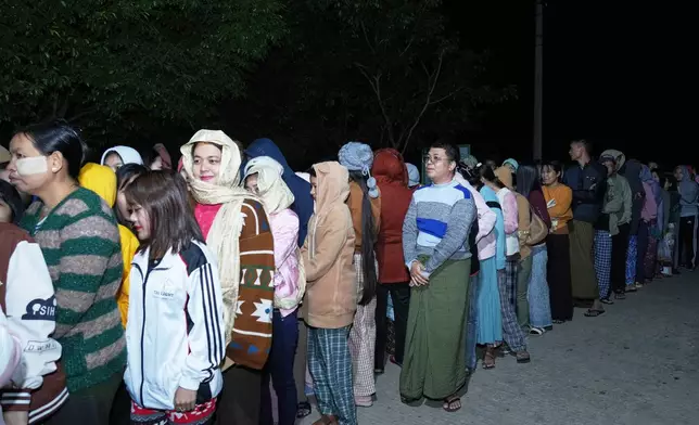 Voters wait for a polling station to open in Naypyitaw, Myanmar, Sunday, Dec. 28, 2025. (AP Photo/Aung Shine Oo)