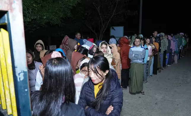 Voters wait for a polling station to open in Naypyitaw, Myanmar, Sunday, Dec. 28, 2025. (AP Photo/Aung Shine Oo)