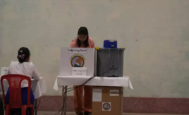 A voter casts a ballot at a polling station, Sunday, Dec. 28, 2025, in Yangon, Myanmar. (AP Photo/Thein Zaw)