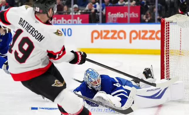 Ottawa Senators right wing Drake Batherson (19) scores on Toronto Maple Leafs goaltender Joseph Woll during the third period of an NHL hockey game in Toronto, Saturday, Dec. 27, 2025. (Frank Gunn/The Canadian Press via AP)