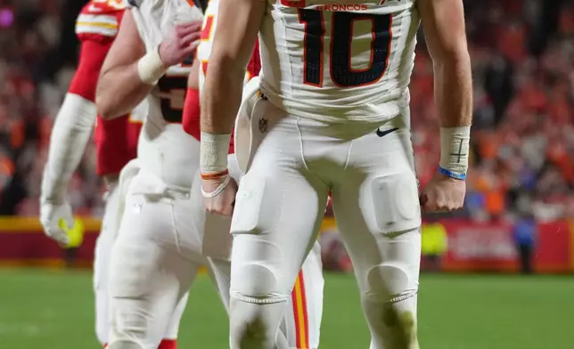 Denver Broncos quarterback Bo Nix (10) reacts after scoring on a touchdown run against the Kansas City Chiefs during the second half of an NFL football game Thursday, Dec. 25, 2025, in Kansas City. (AP Photo/Ed Zurga)