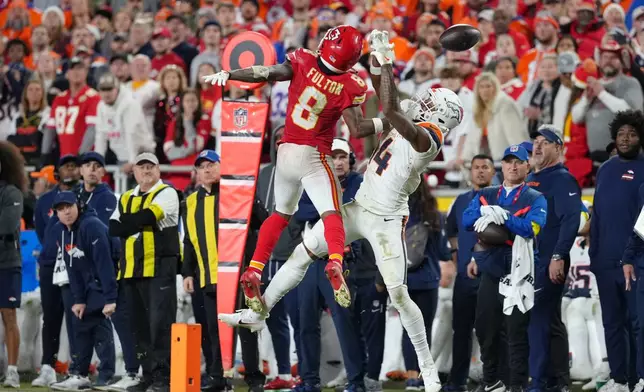 Kansas City Chiefs cornerback Kristian Fulton (8) breaks up a pass intended for Denver Broncos wide receiver Courtland Sutton (14) during the second half of an NFL football game Thursday, Dec. 25, 2025, in Kansas City. (AP Photo/Ed Zurga)