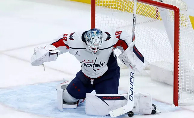 Washington Capitals goaltender Logan Thompson blocks a shot against the Florida Panthers during the second period of an NHL hockey game, Monday, Dec. 29, 2025, in Sunrise, Fla. (AP Photo/Rhona Wise)
