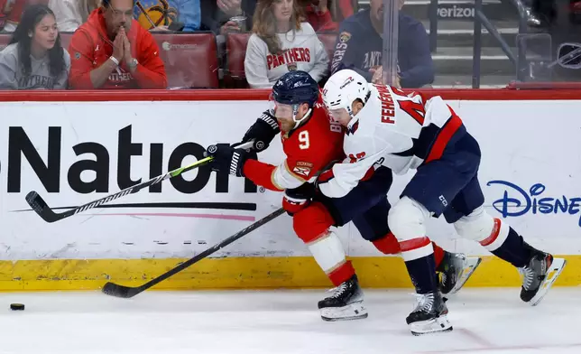 Florida Panthers center Sam Bennett (9)and Washington Capitals defenseman Martin Fehérváry (42) fight for the puck during the second period of an NHL hockey game, Monday, Dec. 29, 2025, in Sunrise, Fla. (AP Photo/Rhona Wise)