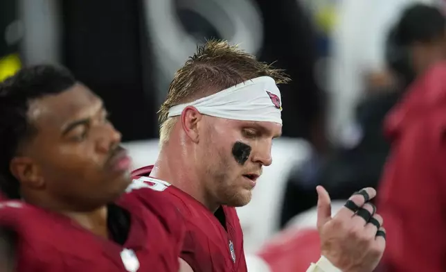 Arizona Cardinals tight end Trey McBride, right, sits on the bench as time runs out in an NFL football game against the Los Angeles Rams, Sunday, Dec. 7, 2025, in Glendale, Ariz. (AP Photo/Ross D. Franklin+