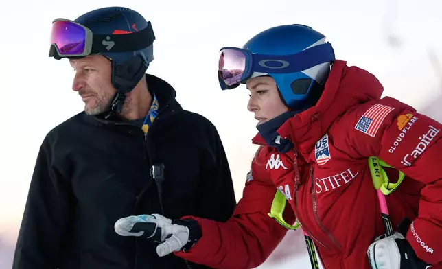 United States' Lindsey Vonn, right, talks to Aksel Lund Svindal as she inspects the course ahead of an alpine ski, women's World Cup downhill, in St. Moritz, Switzerland, Saturday Dec. 13, 2025. (AP Photo/Gabriele Facciotti)